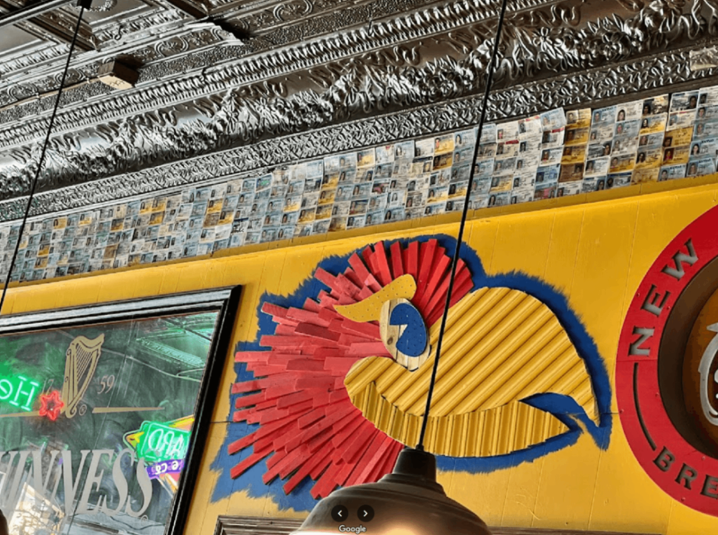 The legendary ID wall inside Louise's Downtown — a Lawrence KS dive bar tradition