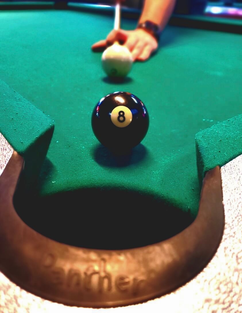 8-ball shot on the pool table at Louise's — best dive bar in Lawrence KS
