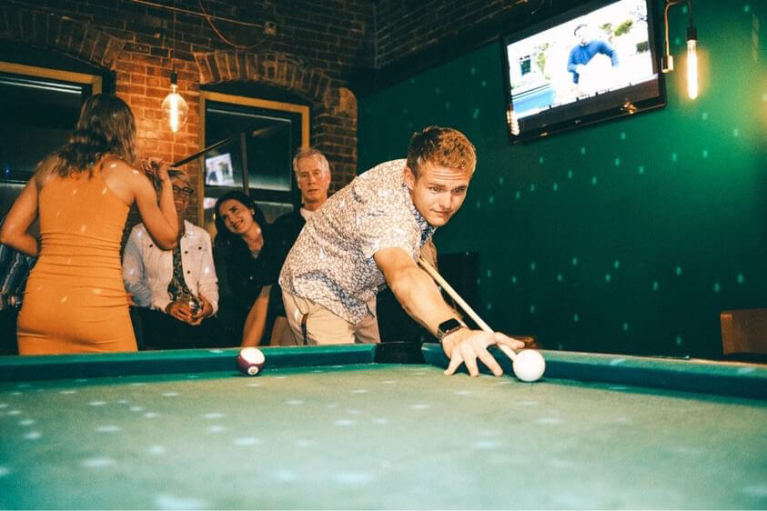 Friends playing pool at Louise's, one of the best bars in downtown Lawrence KS