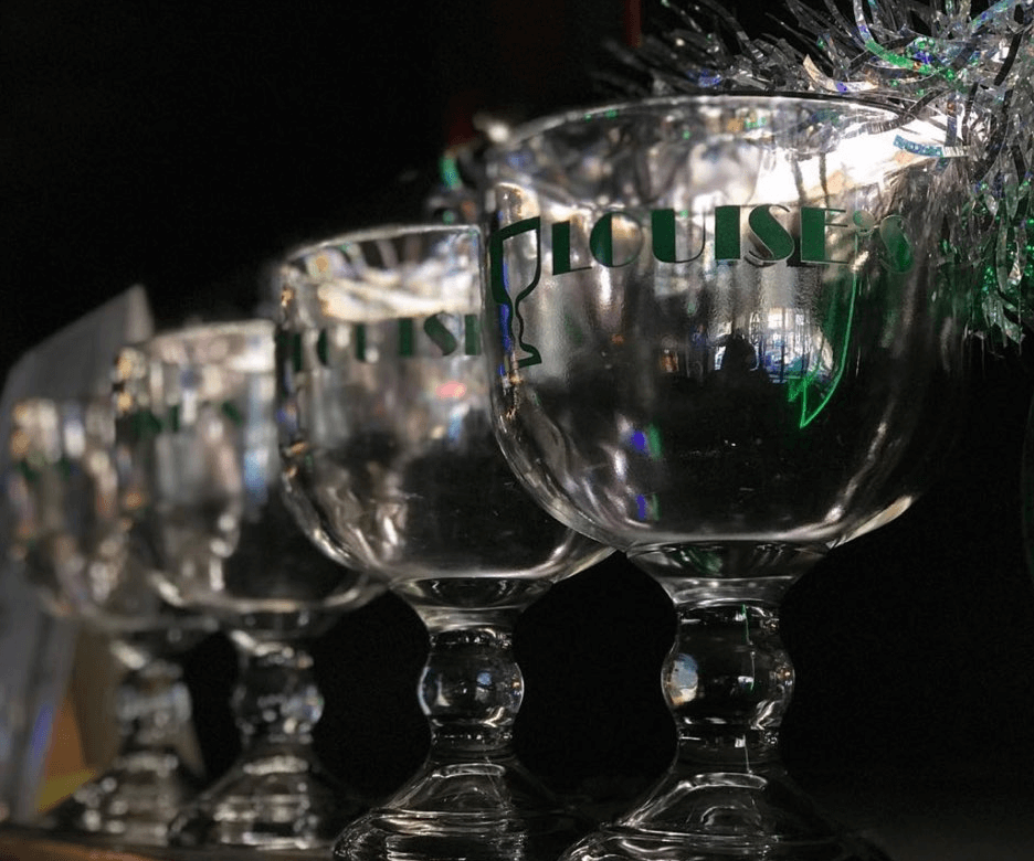 Row of Louise's branded schooner glasses — iconic Lawrence bars